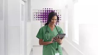 Nurse looking at a screen and smiling 